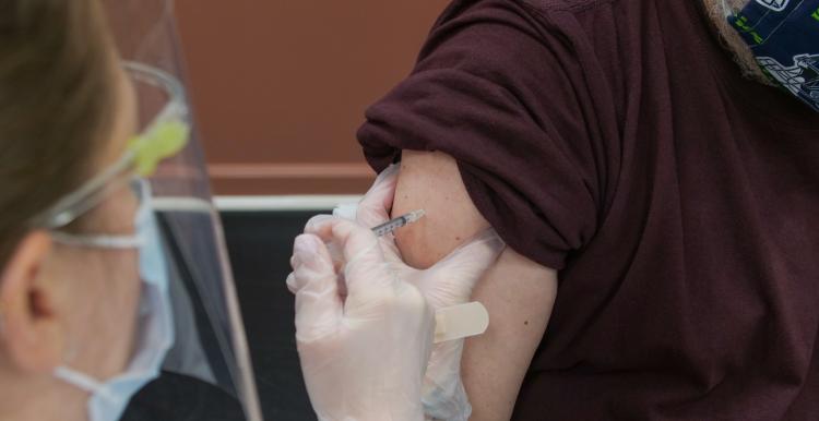 Person receiving a covid vaccine